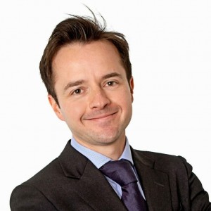 Andre Litwin, consultant ophthalmologist specialising is oculoplastics and glaucoma - he is wearing a dark suit and tie, and a blue shirt